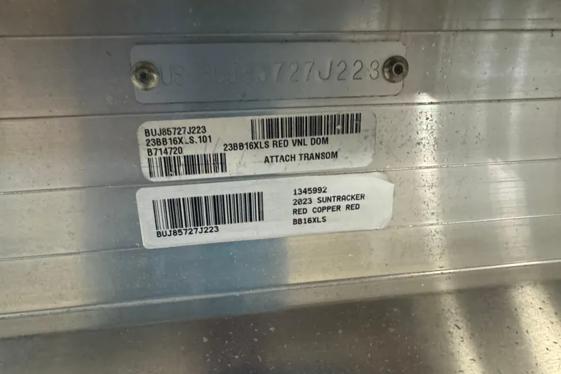 Slide: The Image of 2023 Sun Tracker Bass Buggy 16 XL Select identification labels on metallic surface. - 6