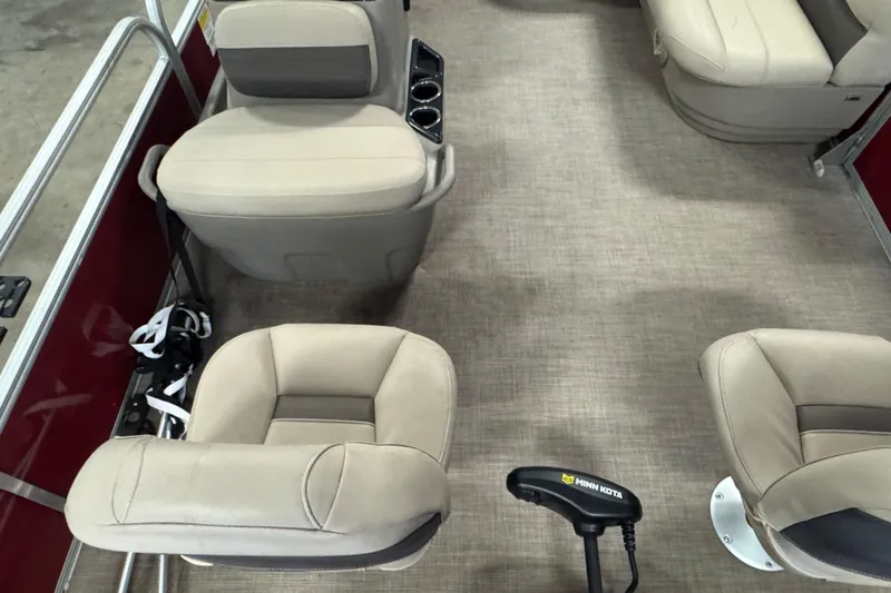 Slide: The Image of 2023 Sun Tracker Bass Buggy 16 XL Select interior with beige seating and Minn Kota trolling motor. - 7