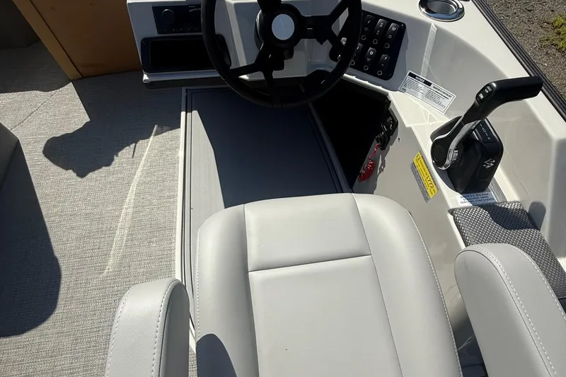 Slide: The Image of Interior of 2025 Crest Classic 200 boat with steering wheel and controls. - 13
