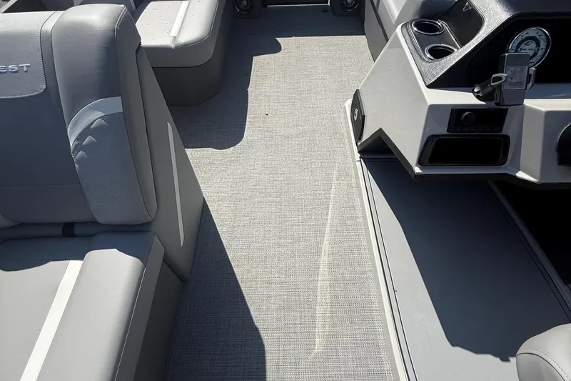 Slide: The Image of Interior of 2025 Crest Classic 200 boat with gray seating and dashboard. - 15