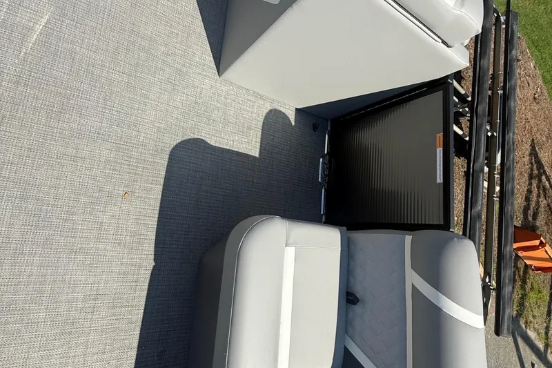 Slide: The Image of Interior of 2025 Crest Classic 200 boat with gray seating and flooring. - 19