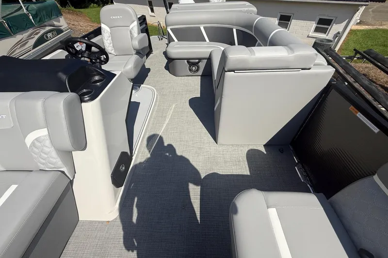 Slide: The Image of 2025 Crest Classic 200 boat interior with gray seating and steering console. - 20