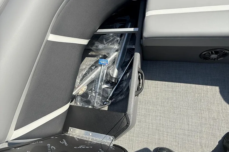 Slide: The Image of 2025 Crest Classic 200 boat interior with storage compartment and seating. - 24