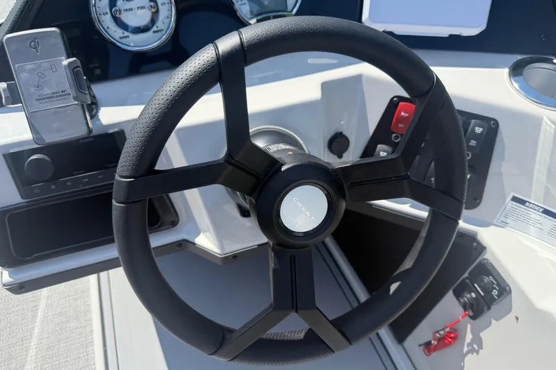 Slide: The Image of Steering wheel of 2025 Crest Classic 200 boat with dashboard controls. - 26