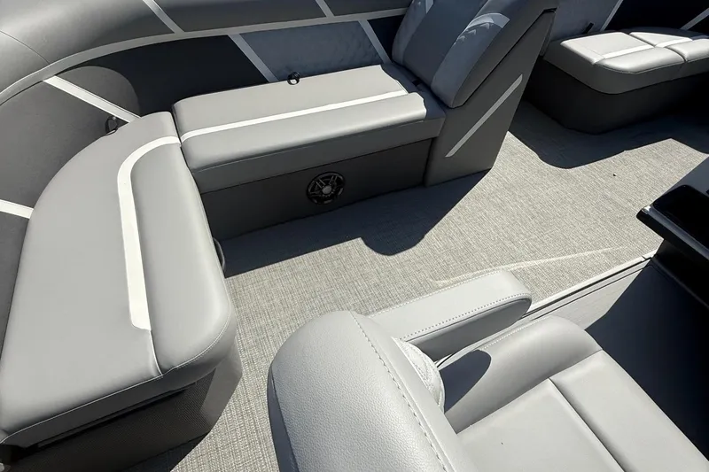 Slide: The Image of 2025 Crest Classic 200 boat interior with gray seating and carpeted flooring. - 30