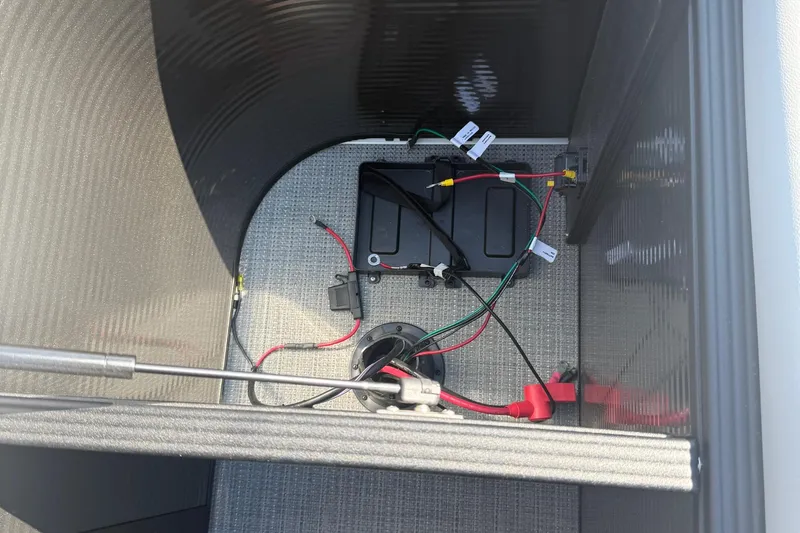 Slide: The Image of 2025 Crest Classic 200 boat wiring and battery compartment with cables and connectors. - 5