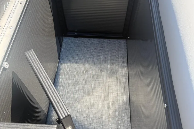 Slide: The Image of Interior view of 2025 Crest Classic 200 storage compartment with textured flooring. - 6