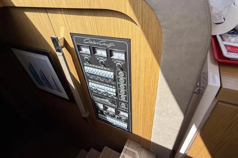 Slide: The Image of Electrical panel on 2018 Chris-Craft Commander 44 yacht interior, featuring gauges and switches. - 13