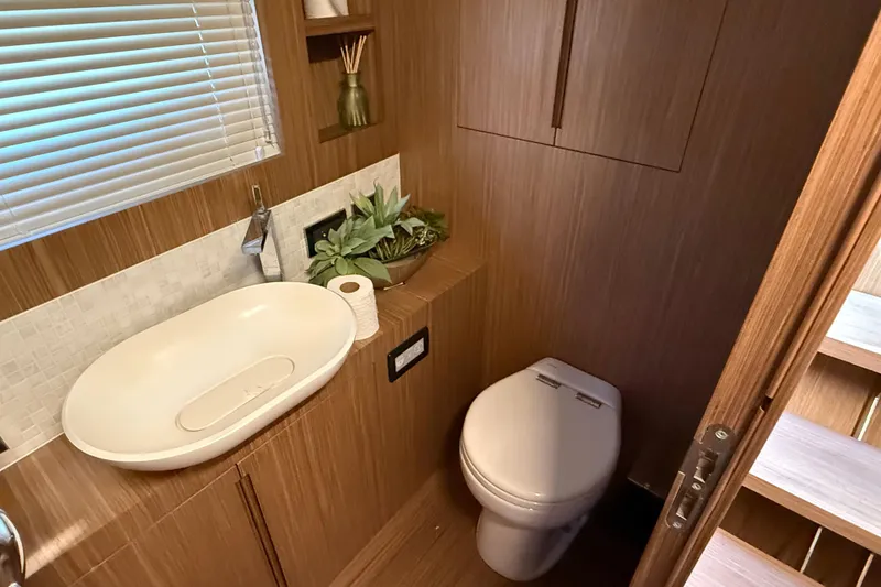 Slide: The Image of Luxurious bathroom in 2018 Chris-Craft Commander 44 yacht with modern fixtures and wooden accents. - 14