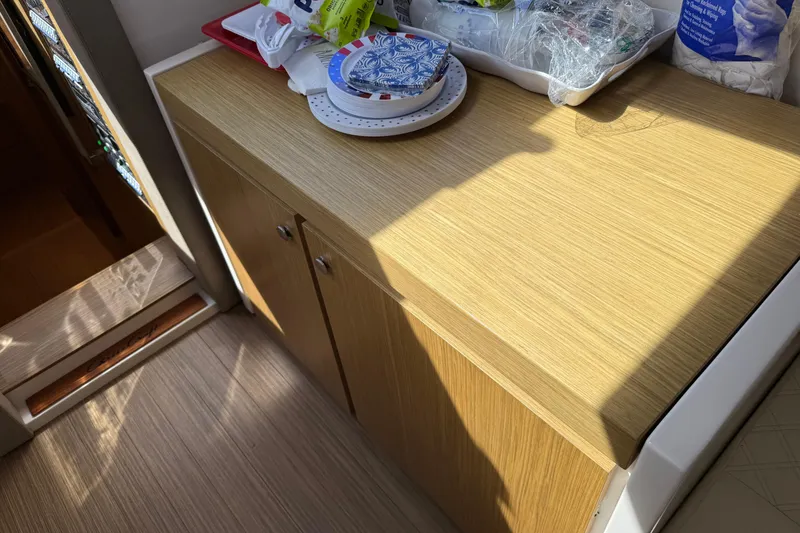 Slide: The Image of Wooden cabinet in 2018 Chris-Craft Commander 44 boat interior, with items on top. - 18