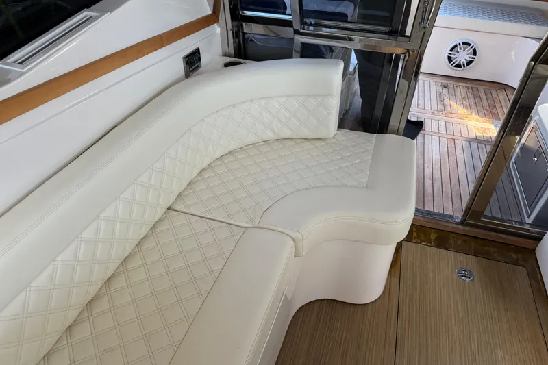Slide: The Image of Luxurious interior seating of 2018 Chris-Craft Commander 44 yacht with elegant white upholstery. - 19