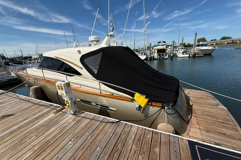 Slide: The Image of 2018 Chris-Craft Commander 44 yacht docked at marina under clear blue sky. - 22