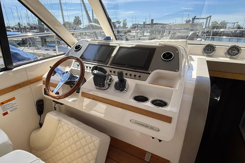 Slide: The Image of 2018 Chris-Craft Commander 44 helm with modern controls and wooden steering wheel. - 6