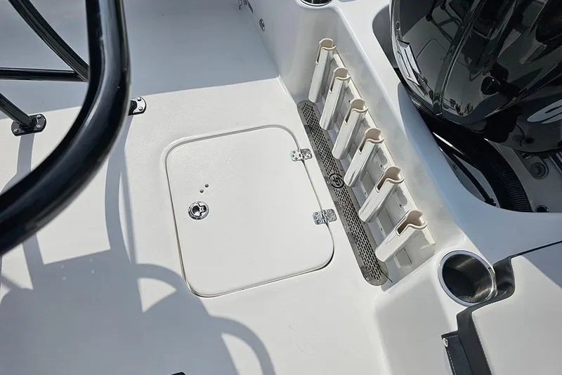 Slide: The Image of 2026 Sea Pro 202 Center Console boat deck with rod holders and storage compartment. - 10
