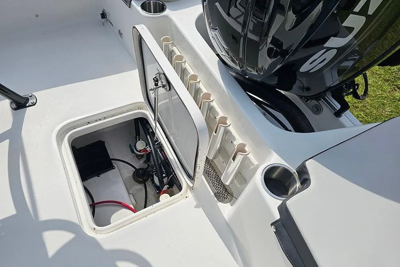Slide: The Image of 2026 Sea Pro 202 Center Console boat with open storage compartment and engine detail. - 11