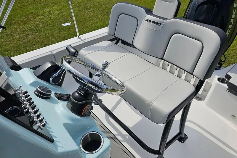 Slide: The Image of 2026 Sea Pro 202 Center Console boat interior with steering wheel and seating. - 12