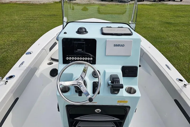 Slide: The Image of 2026 Sea Pro 202 Center Console boat with modern steering and navigation system. - 13