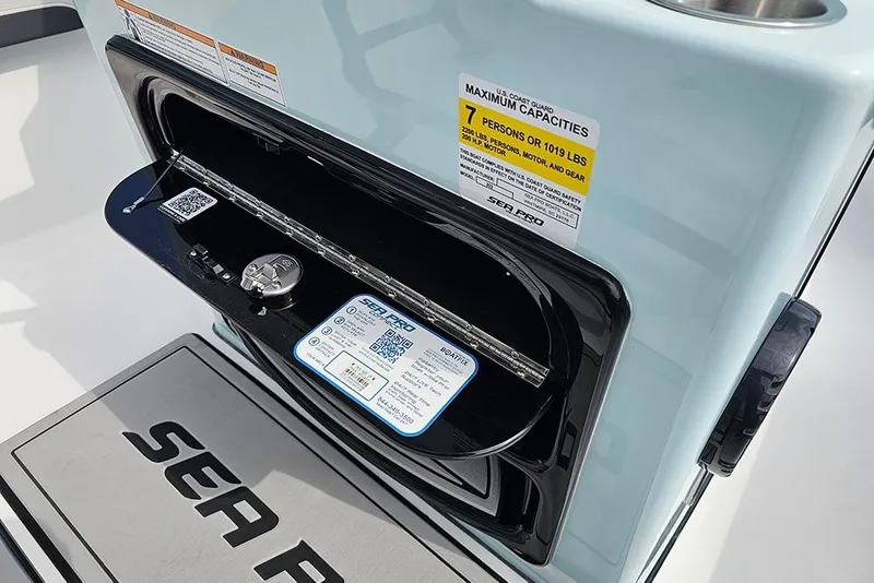 Slide: The Image of 2026 Sea Pro 202 Center Console boat dashboard with capacity label and storage compartment. - 14
