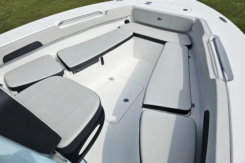 Slide: The Image of 2026 Sea Pro 202 Center Console boat interior with cushioned seating and storage compartments. - 19