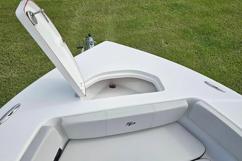 Slide: The Image of 2026 Sea Pro 202 Center Console boat with open storage compartment on grassy background. - 24