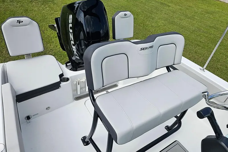 Slide: The Image of 2026 Sea Pro 202 Center Console boat interior with Suzuki engine and cushioned seating. - 8