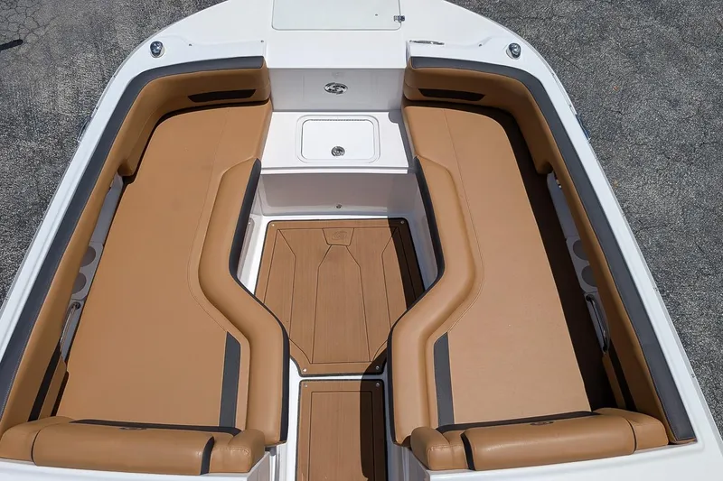 Slide: The Image of 2023 Hurricane SunDeck 235 OB boat interior with tan seating and storage compartments. - 14