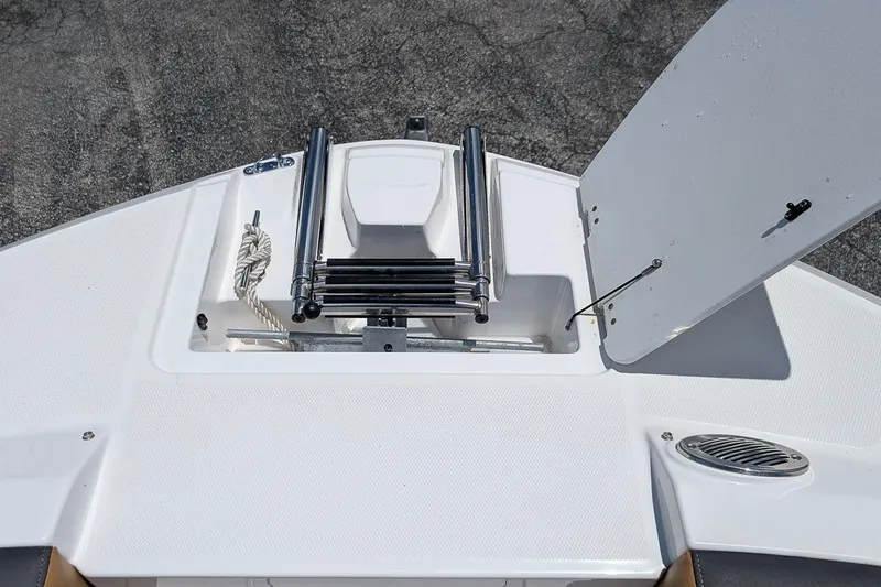Slide: The Image of 2023 Hurricane SunDeck 235 OB boat deck with ladder and storage compartment. - 17