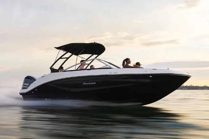 Slide: The Image of Manufacturer Provided Image: 2023 Hurricane SunDeck 235 OB boat cruising on water at sunset. - 18