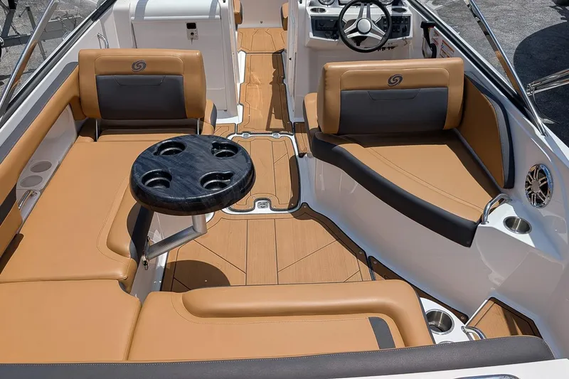 Slide: The Image of 2023 Hurricane SunDeck 235 OB boat interior with tan seating and black table. - 4