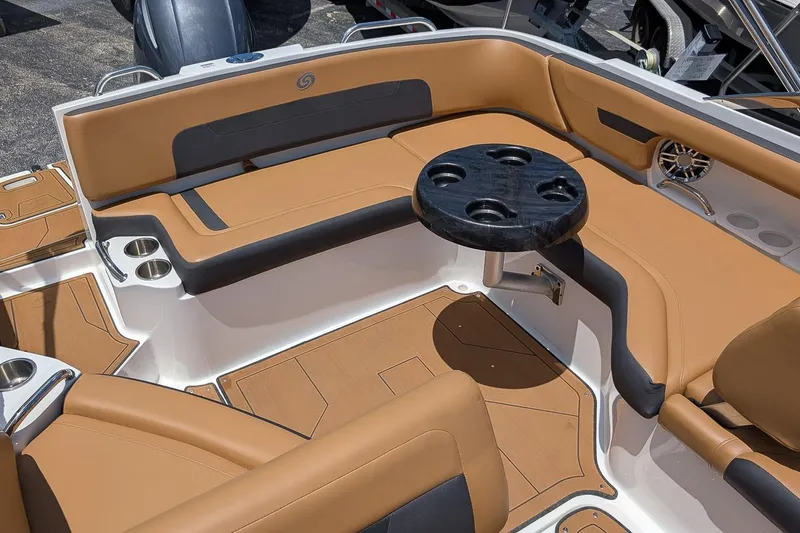 Slide: The Image of 2023 Hurricane SunDeck 235 OB interior with tan seating and round table. - 5