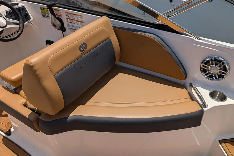 Slide: The Image of 2023 Hurricane SunDeck 235 OB boat interior with tan and gray seating, cup holder, and speaker. - 6
