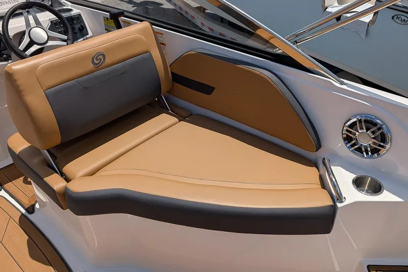 Slide: The Image of 2023 Hurricane SunDeck 235 OB boat interior with tan and gray seating, cup holder, and speaker. - 7