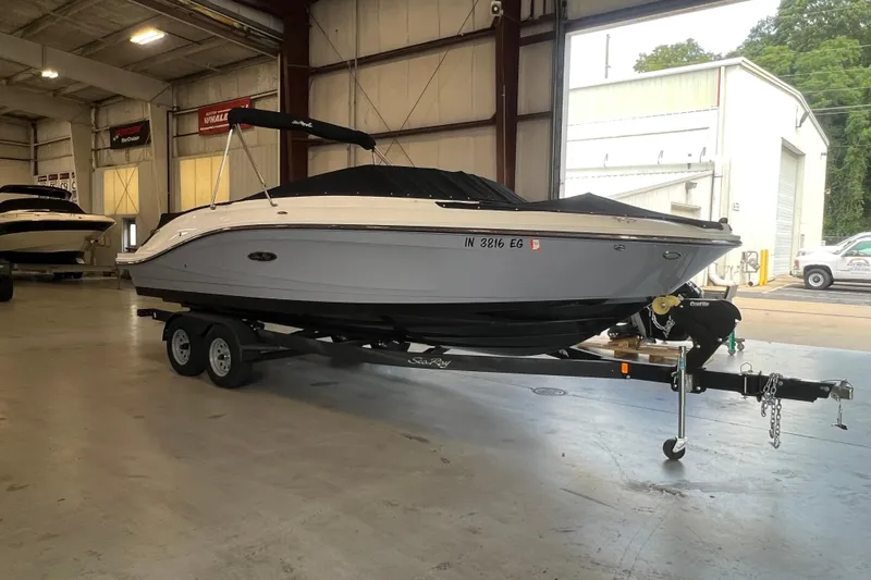 Slide: The Image of 2021 Sea Ray SPX 230 boat on trailer in indoor storage facility. - 1