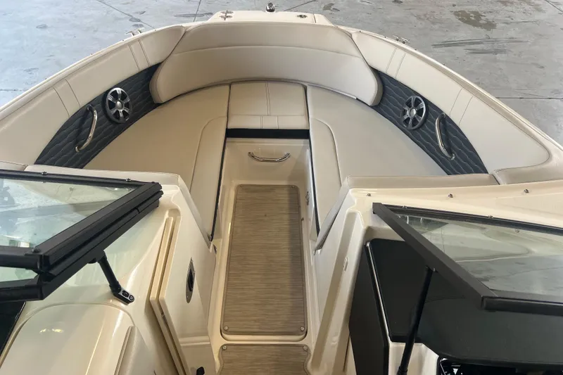 Slide: The Image of 2021 Sea Ray SPX 230 boat interior with beige seating and modern design. - 10