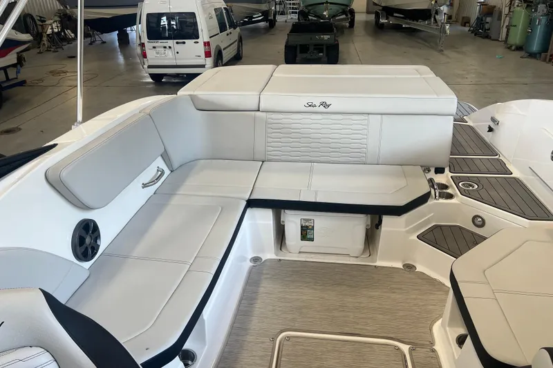 Slide: The Image of 2021 Sea Ray SPX 230 boat interior with white seating in a showroom. - 11