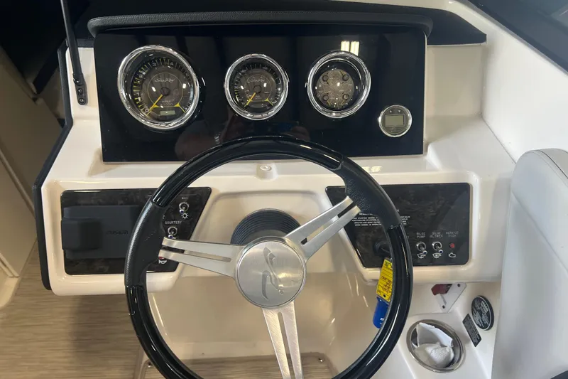 Slide: The Image of 2021 Sea Ray SPX 230 dashboard with steering wheel and instrument panel. - 12