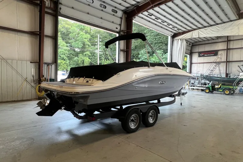 Slide: The Image of 2021 Sea Ray SPX 230 boat on trailer in indoor storage facility. - 2