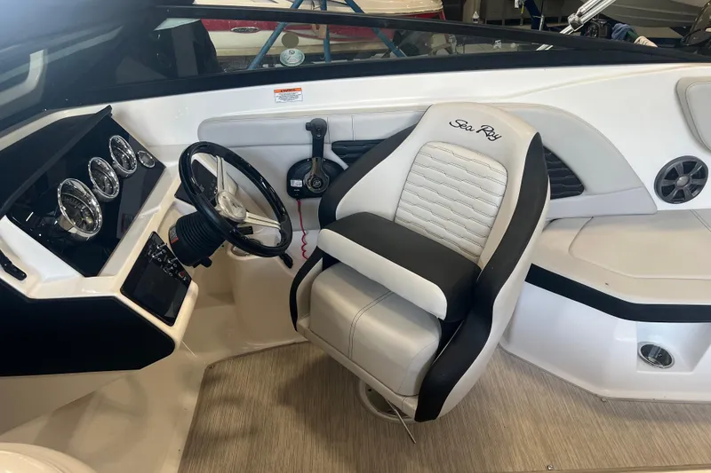 Slide: The Image of 2021 Sea Ray SPX 230 boat interior with steering wheel and captain's seat. - 6