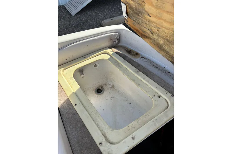Slide: The Image of Open storage compartment in a 2000 Crownline 180 BR boat. - 11