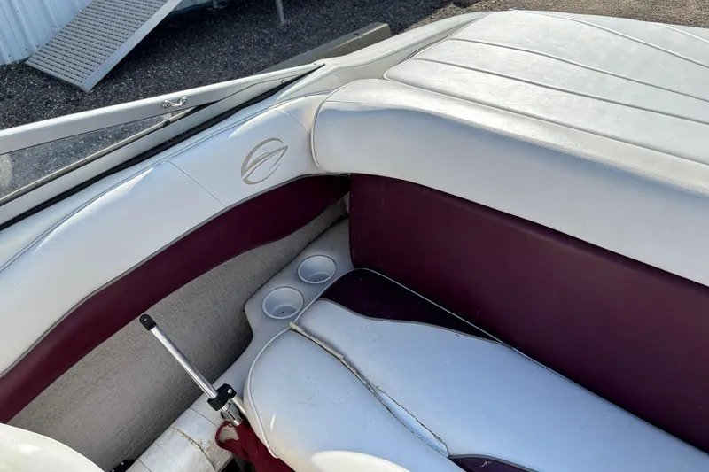 Slide: The Image of Interior of a 2000 Crownline 180 BR boat with white and maroon seating. - 14