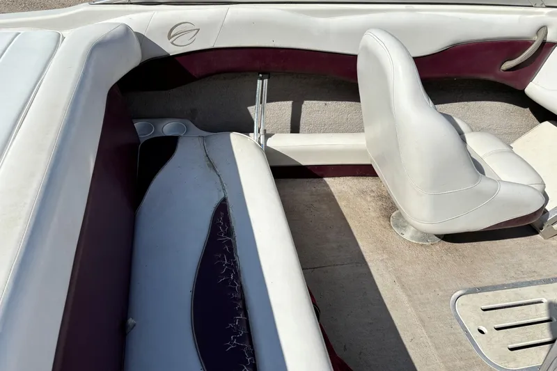 Slide: The Image of Interior of a 2000 Crownline 180 BR boat with white and maroon seating. - 17