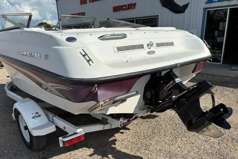 Slide: The Image of 2000 Crownline 180 BR boat on trailer, rear view, with Mercury engine. - 4