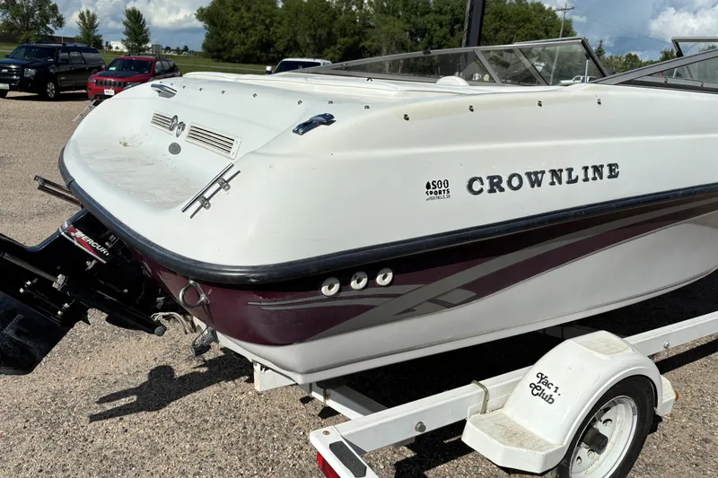 Slide: The Image of 2000 Crownline 180 BR boat on trailer, rear view, parked outdoors. - 6