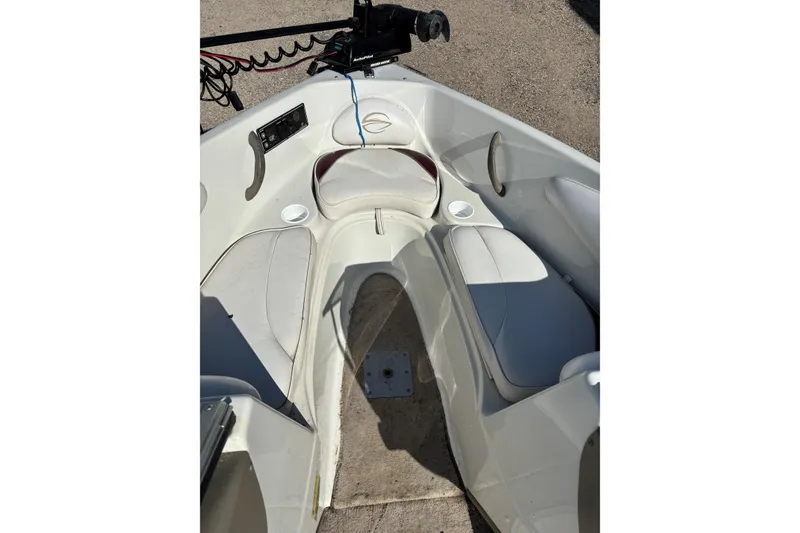 Slide: The Image of Interior of a 2000 Crownline 180 BR boat with white seating and cup holders. - 8