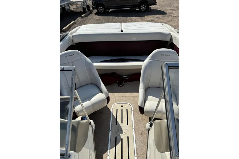 Slide: The Image of Interior of 2000 Crownline 180 BR boat with white seating and open deck layout. - 9