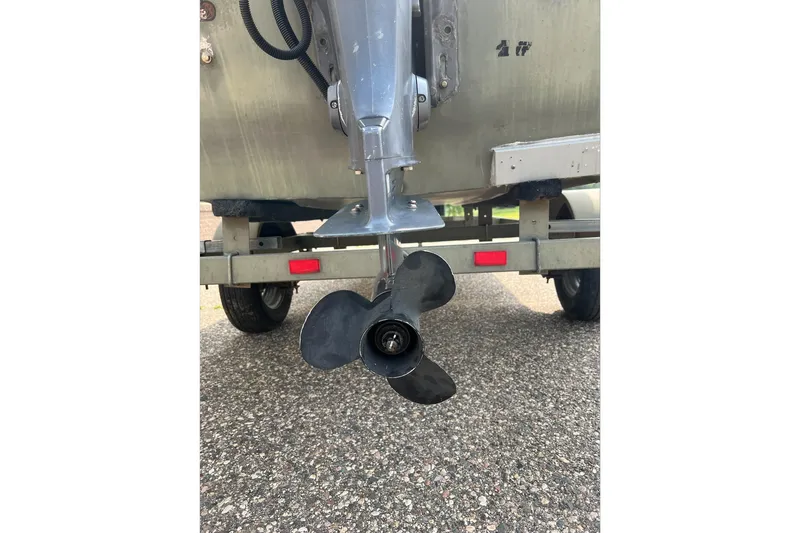 Slide: The Image of Propeller of a 2011 Tracker 1754 boat on a trailer, close-up view. - 14