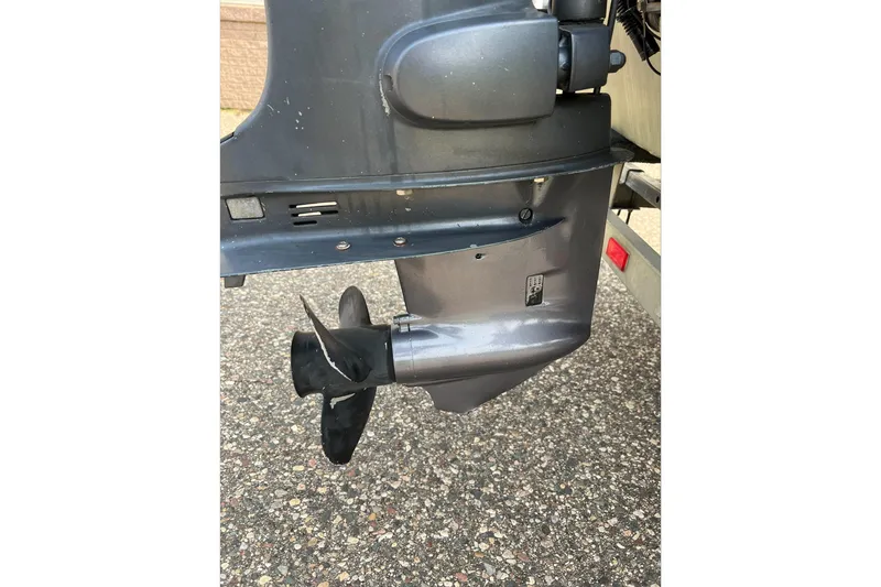 Slide: The Image of 2011 Tracker 1754 boat motor propeller on asphalt surface. - 7