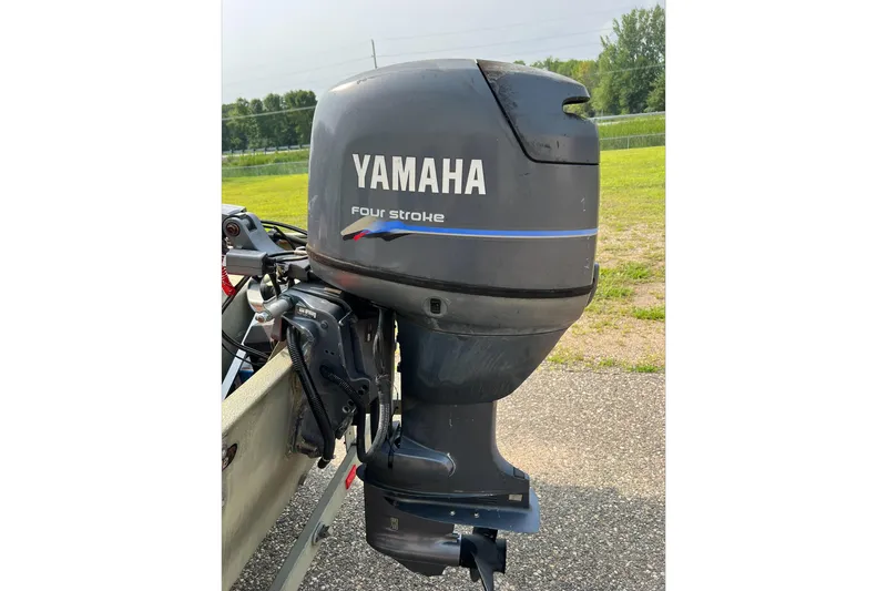 Slide: The Image of Yamaha four-stroke outboard motor on 2011 Tracker 1754 boat, parked outdoors. - 9