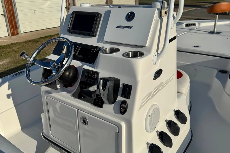 Slide: The Image of 2015 Epic 22 Sport Console boat dashboard with steering wheel and controls. - 11