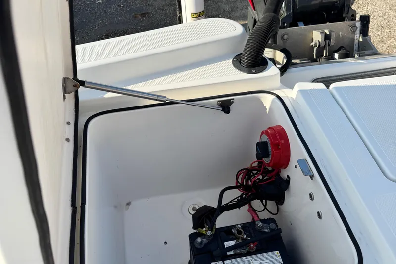 Slide: The Image of Open battery compartment of 2015 Epic 22 Sport Console boat, showing wiring and components. - 16